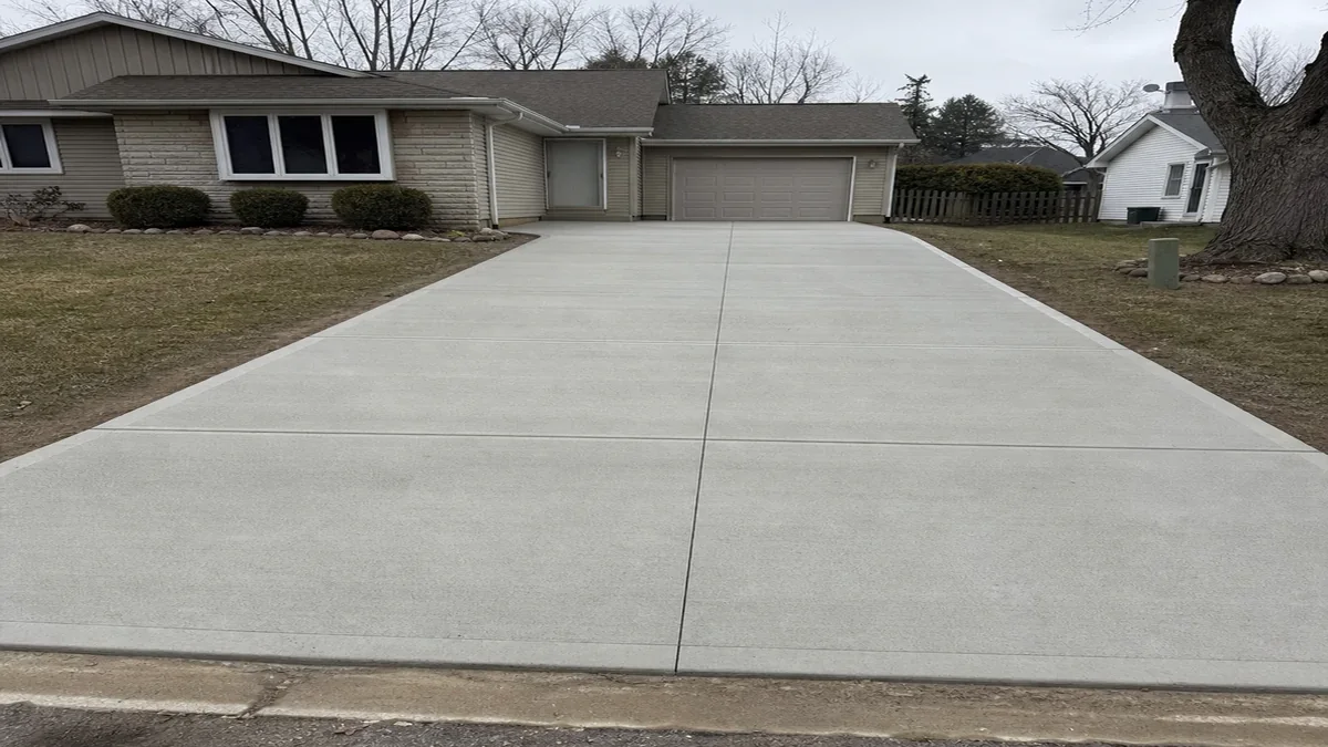 Finished broom-finished concrete driveway slab in South Bend Indiana with clean control joints and garage approach