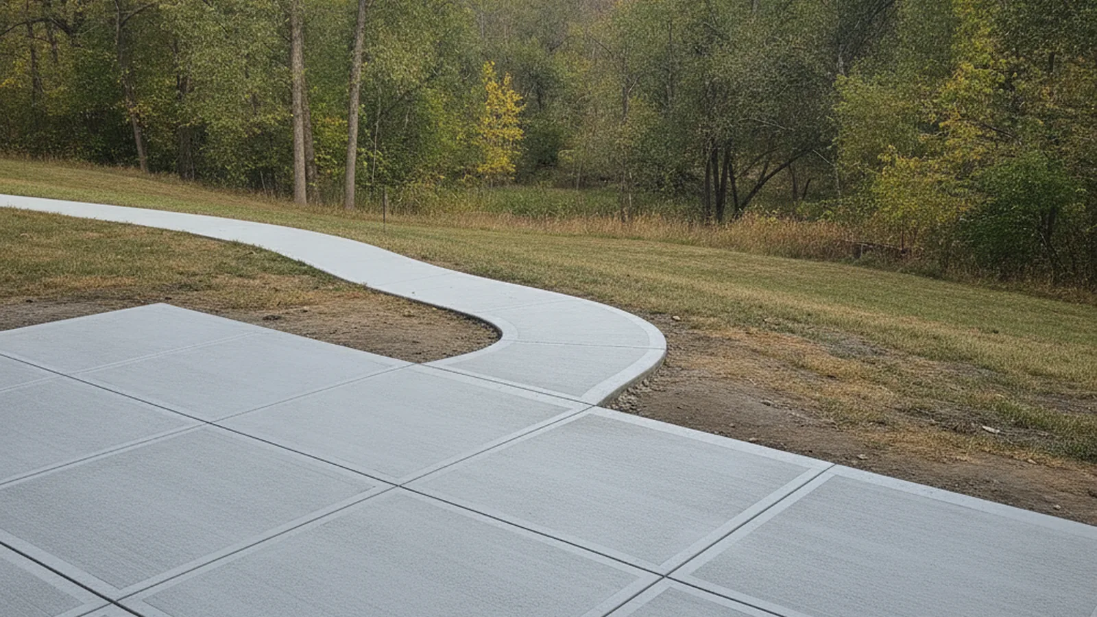 Residential concrete driveway on gently rolling terrain